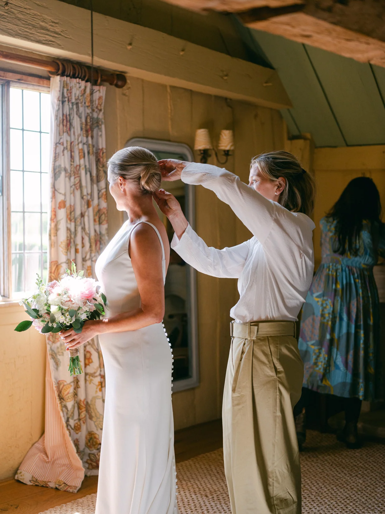 Charlotte finishing bridal hair on the wedding morning