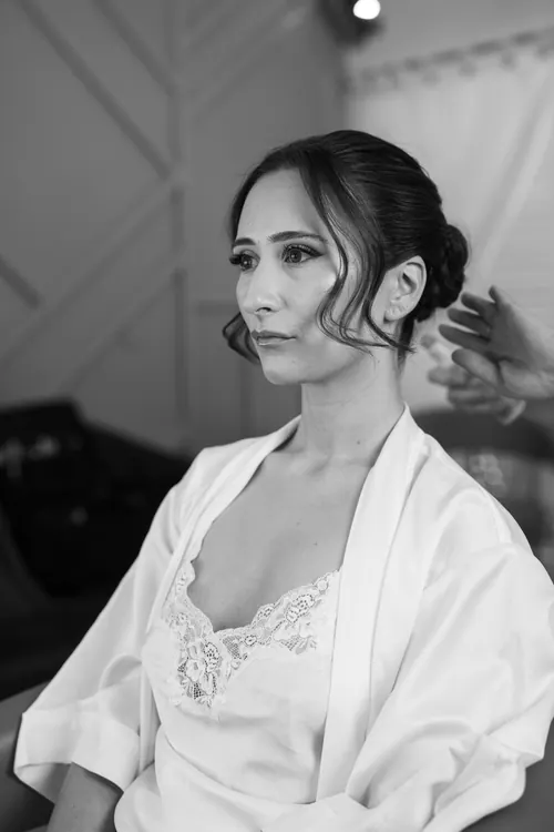 Sleek low bun with face framing waves - Photography by Gemma Pimm