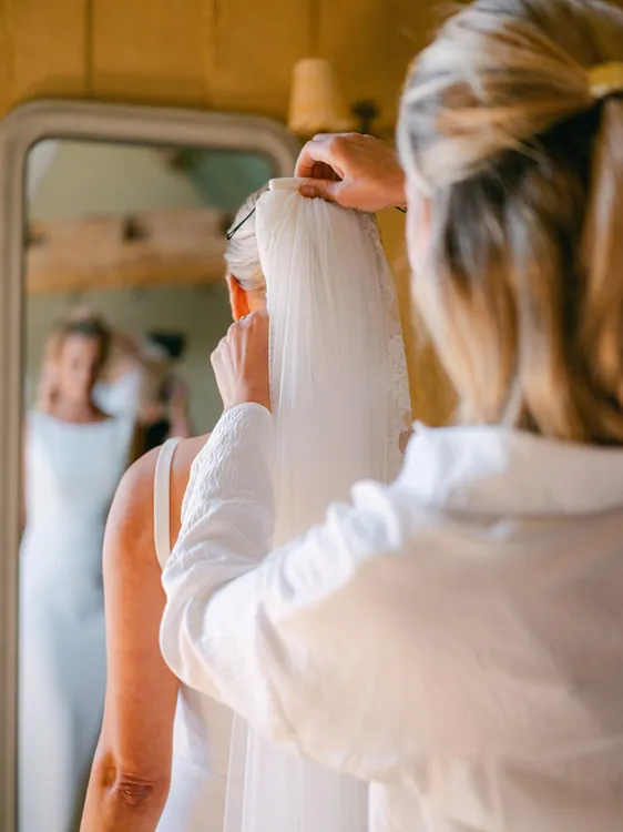 Charlotte securing her bride's veil - Photography by Faye Taylor