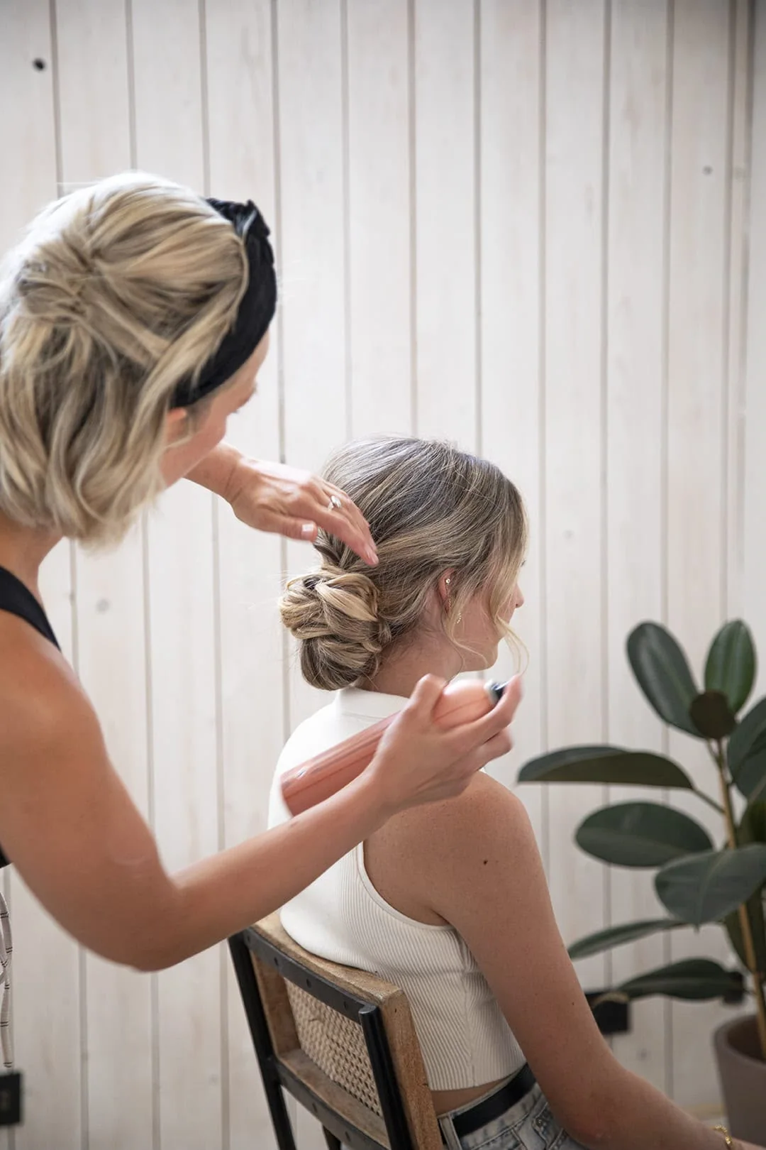 Charlotte perfecting her bride's bridal updo