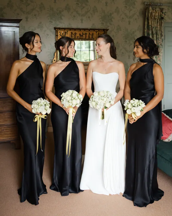 Bride with bridesmaids in elegant dark dresses