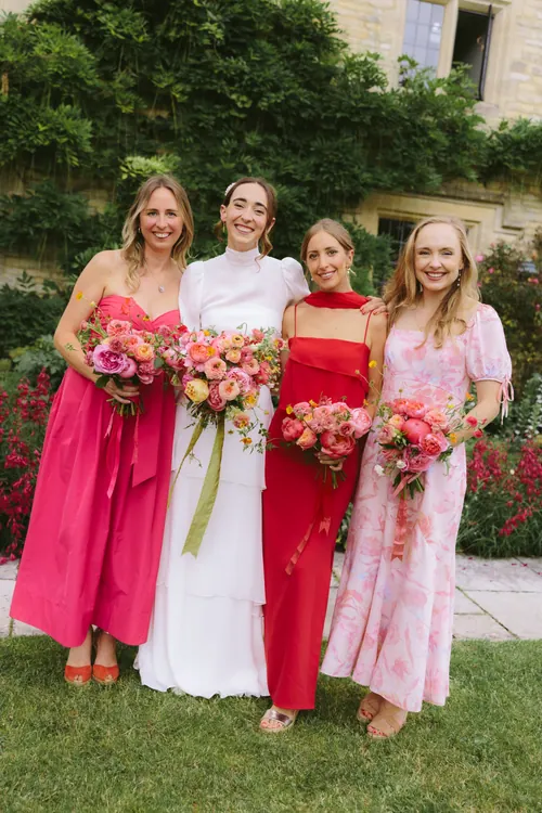 Bride and bridesmaids holding vibrant flowers