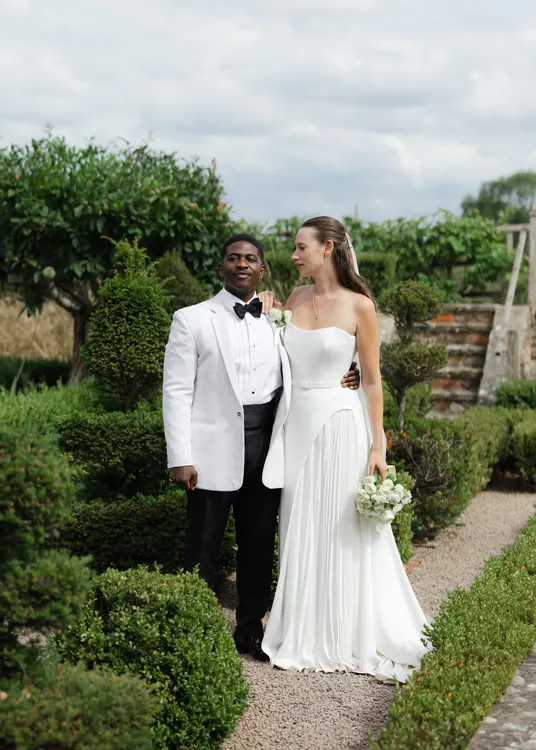 Couple in a garden following their wedding ceremony